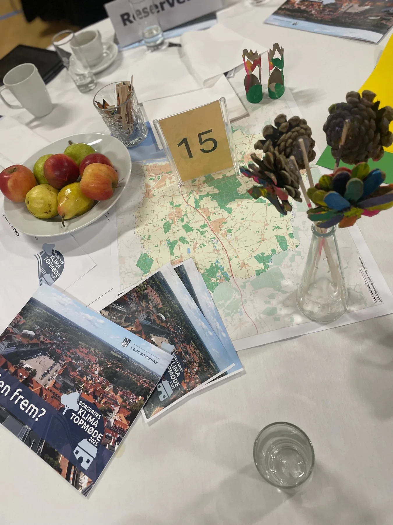 Maps, fruit and handmade objects on a table at a citizens' meeting