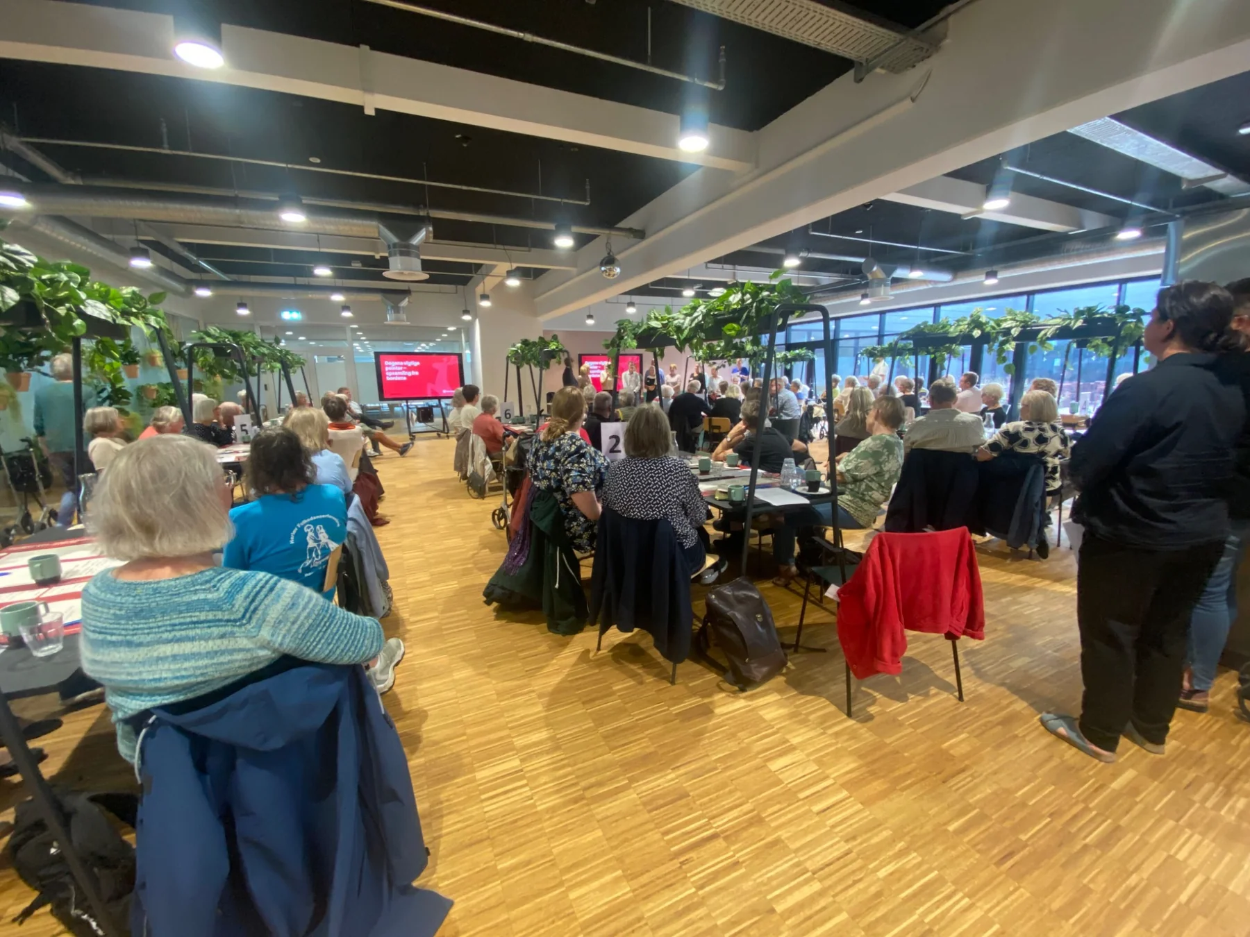 Participants seated at tables during a local public meeting